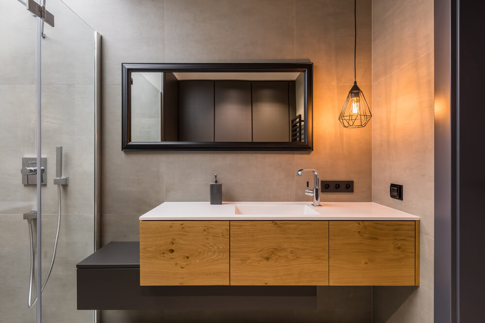 grey bathroom design facing the benchtop and lighted nordic lamp