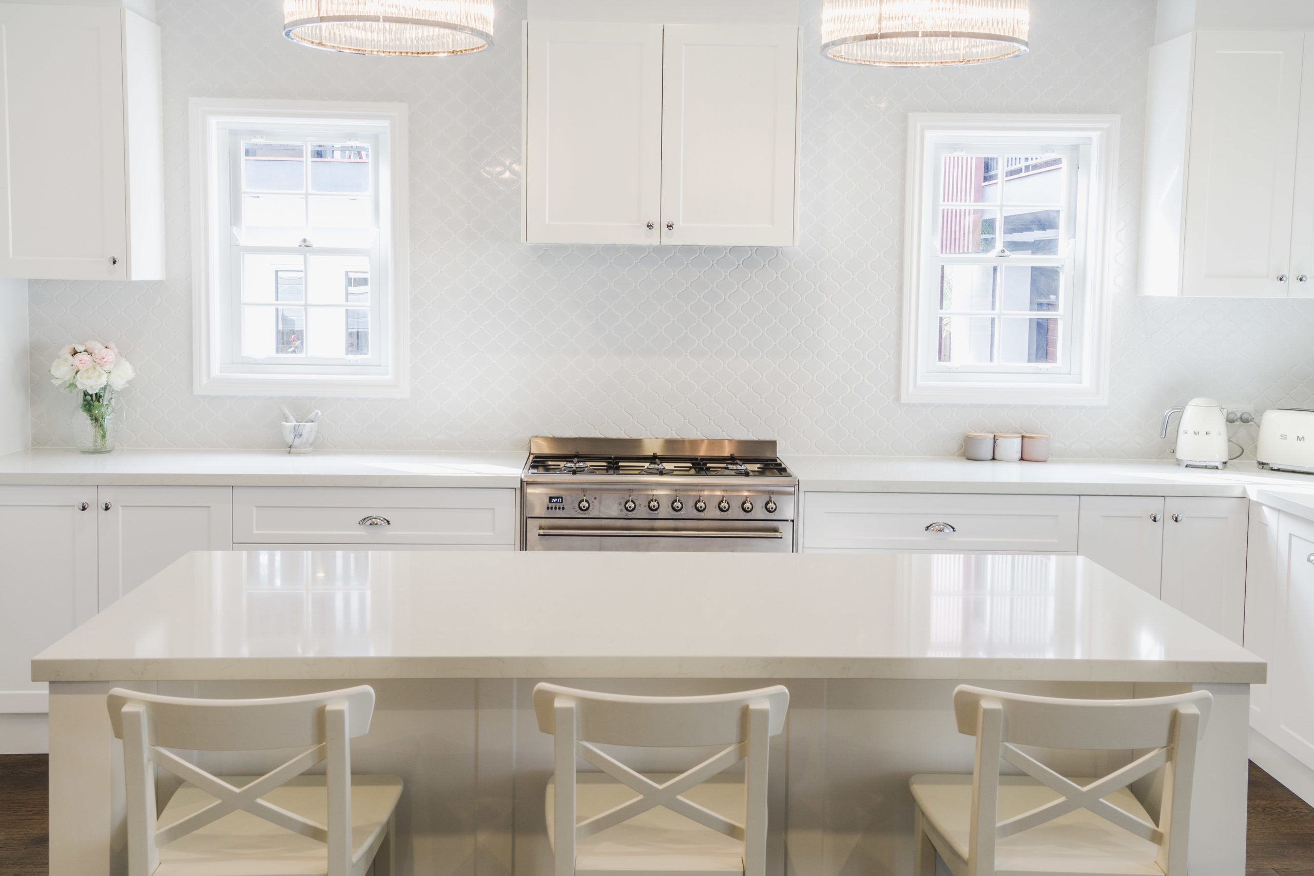 all-white kitchen with white cabinetry and benchtop