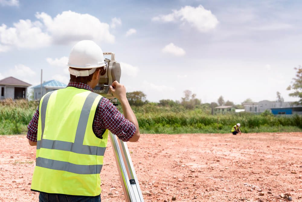 male land surveyor inspecting site