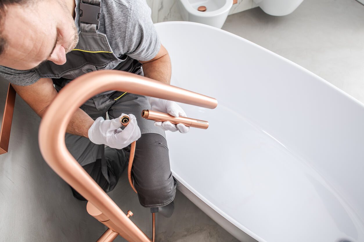 plumber installing bath tubs for bathroom