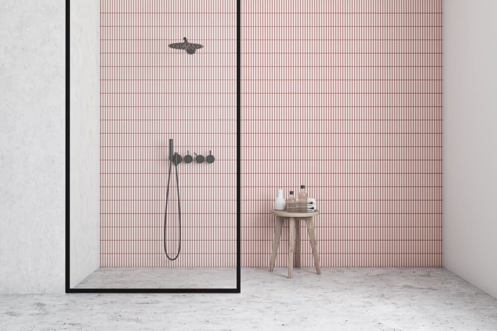 walk-in shower with pink tiles