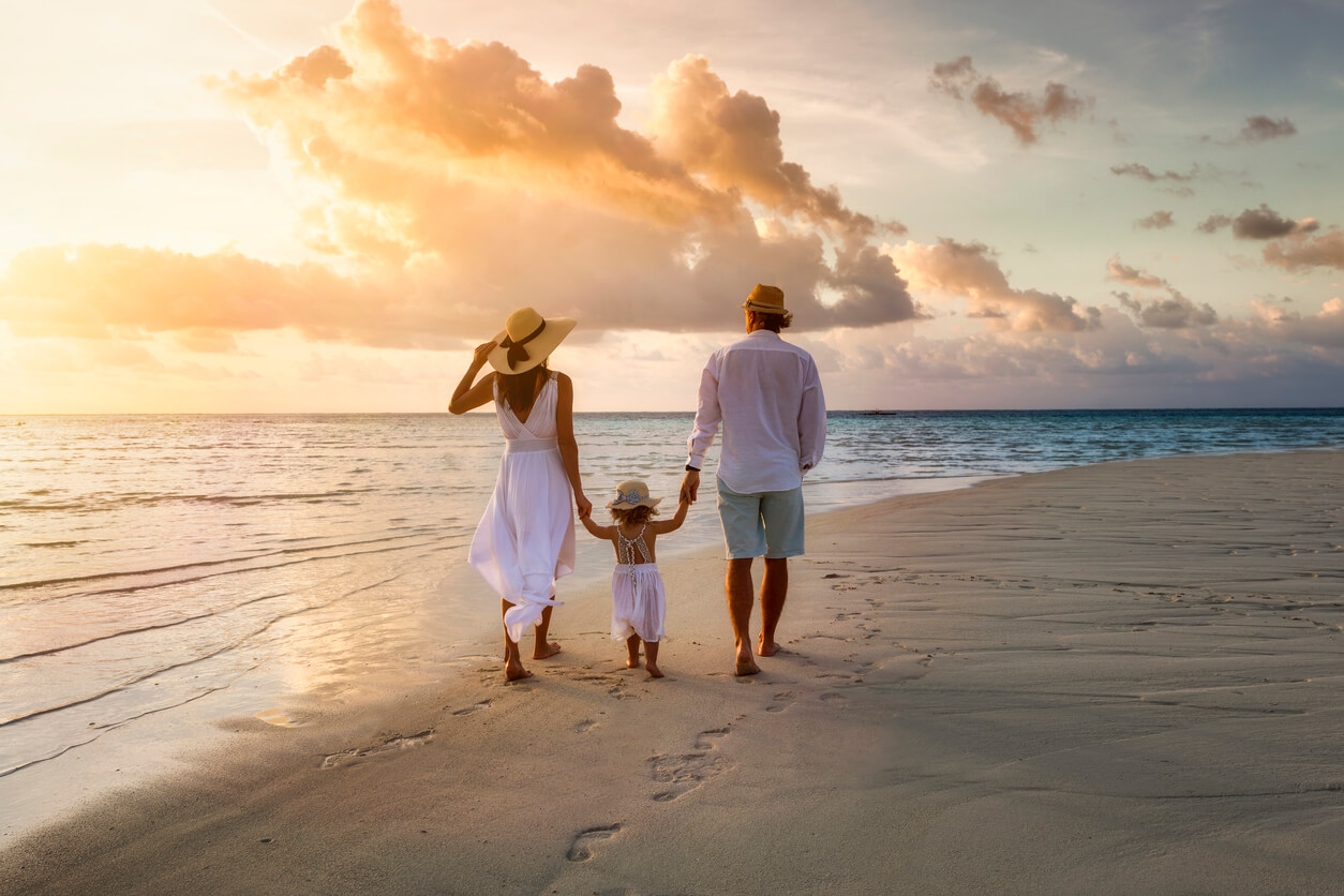 family enjoying a sunset walk in a coastal area