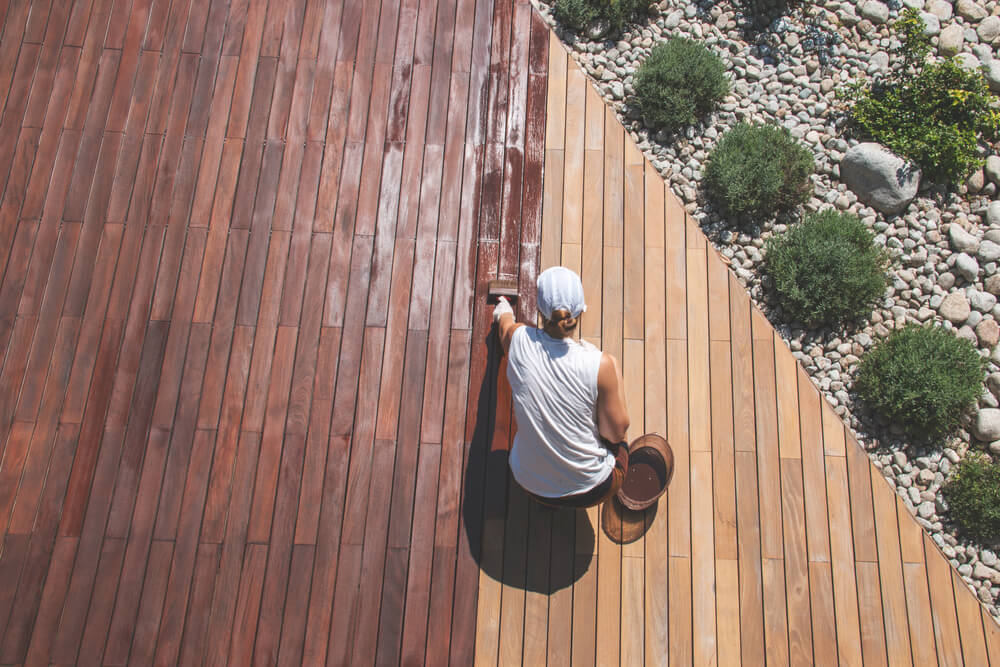 woman renovating an outdoor deck